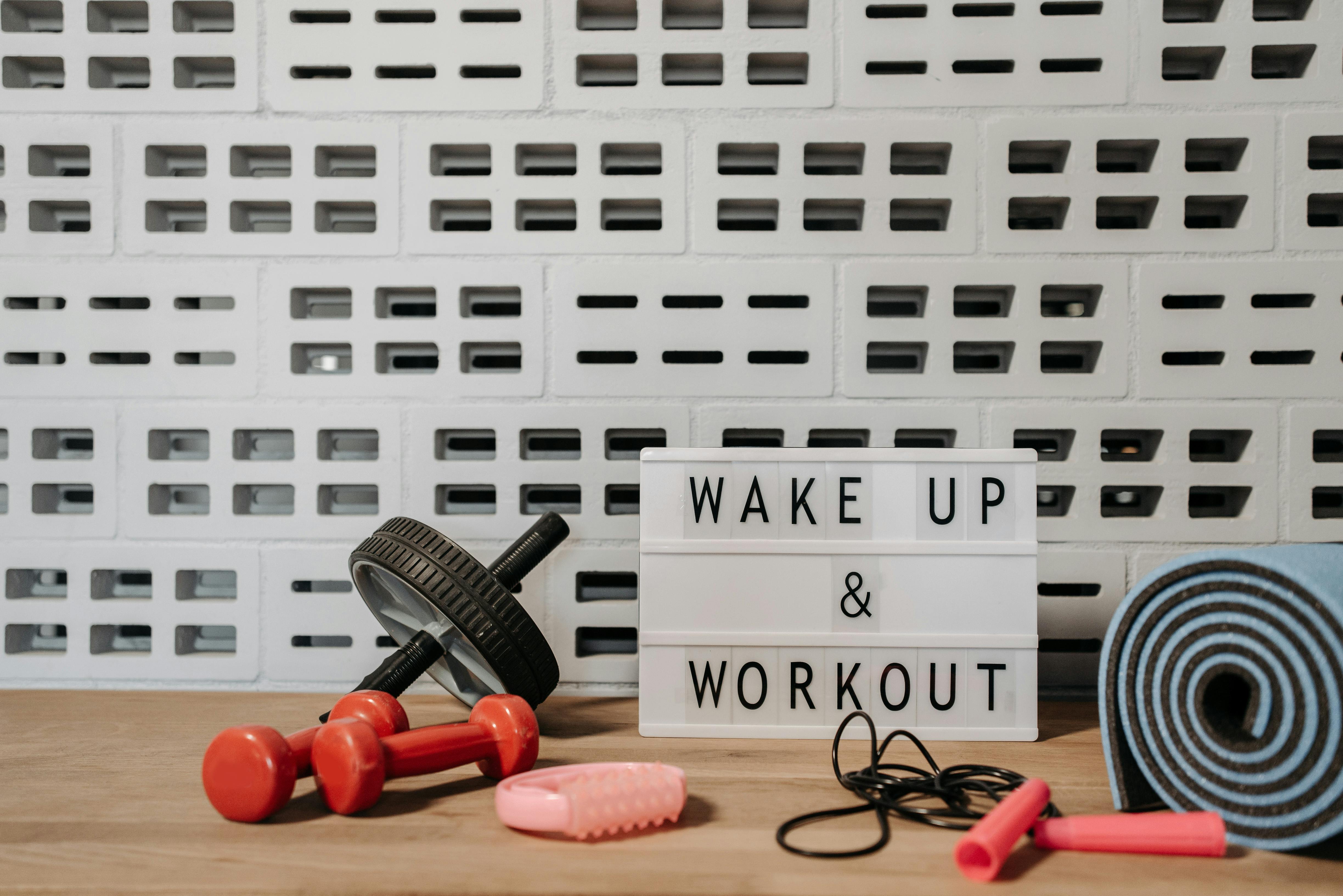 Workout equipment with a sign that says WAKE UP & WORK OUT